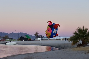 Balloons on the beach at sunrise