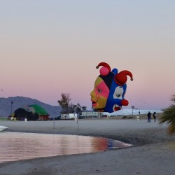 Balloons on the beach at sunrise